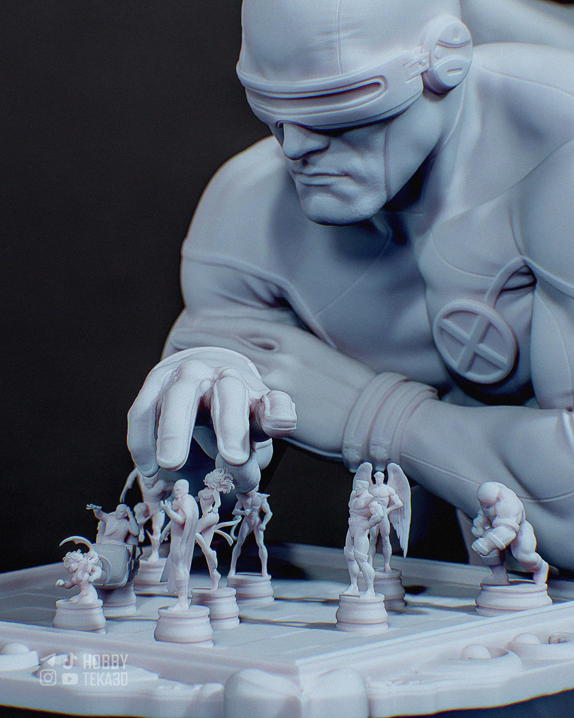 Unpainted superhero resin figure leaning over a chessboard with miniature comic character pieces and visor helmet